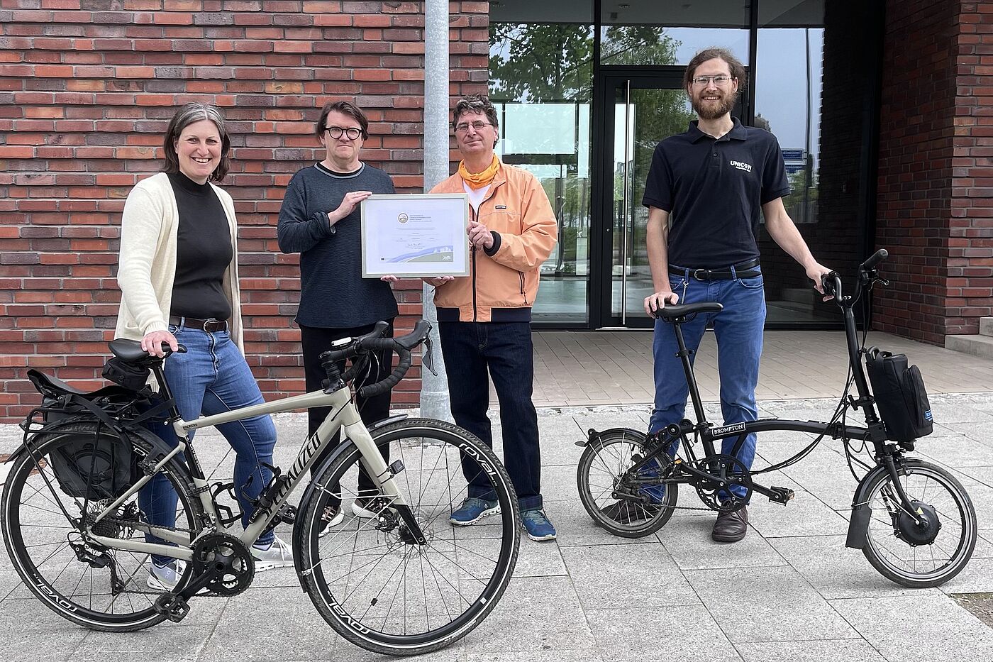 Das Bild zeigt die Zertifikats-Übergabe mit Verena Reuter (Vorstand ADFC NRW), Gernot Steinberg (Geschäftsführer Planersocietät), Andreas K. Bittner (ADFC Projekt Fahrradfreundlicher Arbeitgeber), Felix Regelsberger (Radverkehrsbeauftragter Planersocietät).
