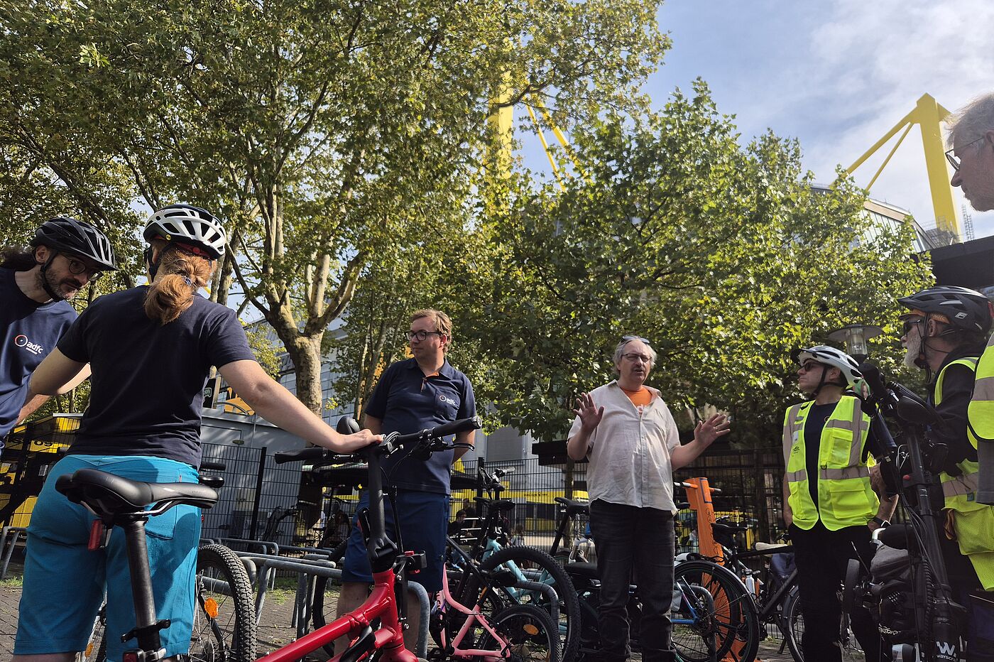 2025-09_Exkursion_Mobilitaet_Dortmund__ADFC_NRW Menschen in Areal der Radwache, im Hintergrund das Stadion.